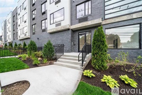 A modern building with a black railing and a glass door.