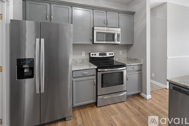 A kitchen with a stainless steel refrigerator and oven.