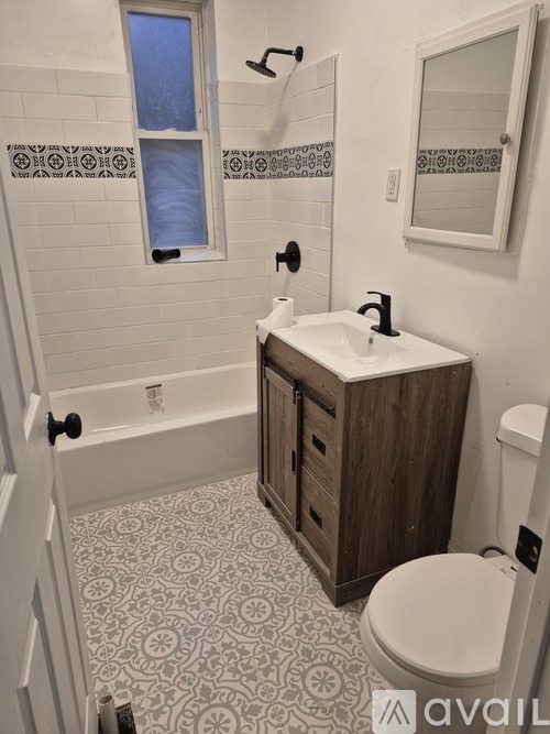 A bathroom with a toilet, sink, and a bathtub.