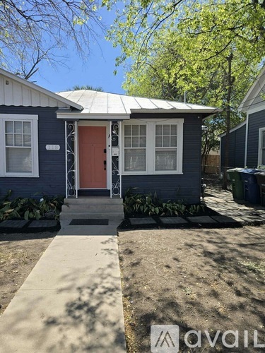 A small house with a red door is for sale.