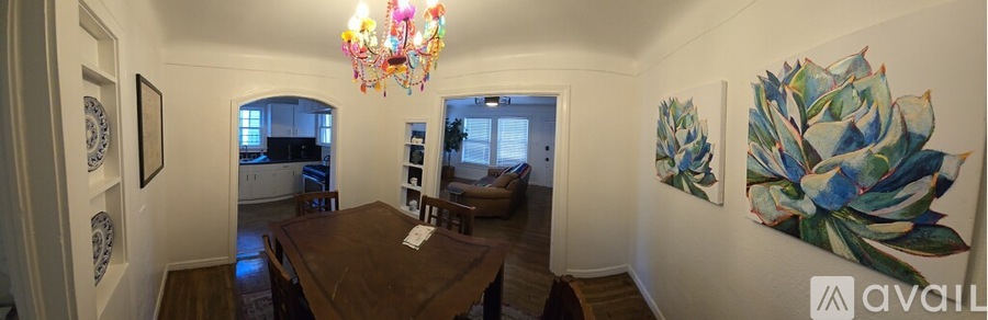 A dining room with a wooden table and chairs.