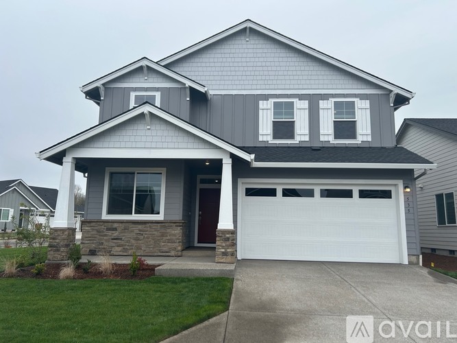 A two-story house with a garage and a front porch.