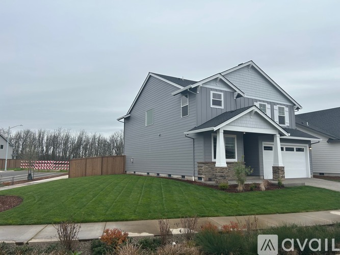 A house with a grey exterior and a white garage door.