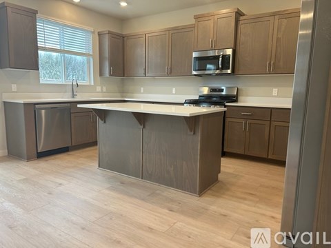 A kitchen with wooden cabinets and a white countertop.