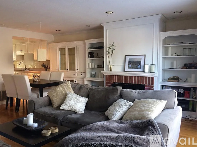 A living room with a grey couch and a coffee table.