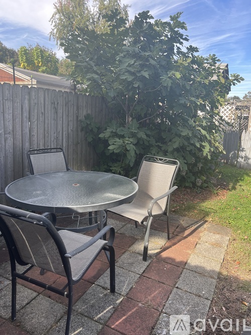 A patio with a table and two chairs.