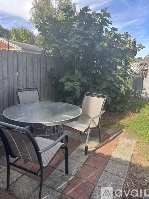 A patio with a table and two chairs.