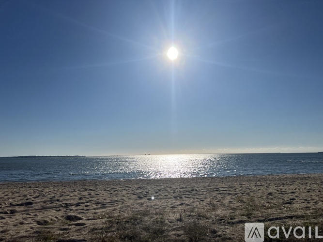 The sun is shining brightly over a sandy beach.