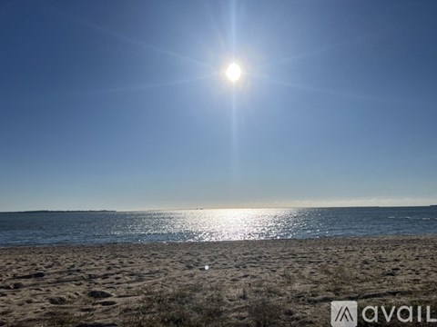 The sun is shining brightly over a sandy beach.