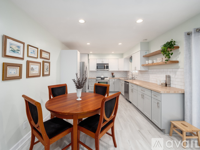 A dining room with a wooden table and chairs.