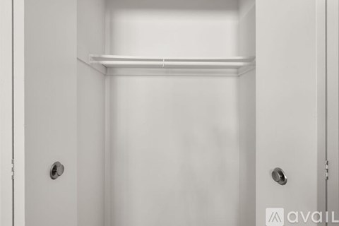 A white door with a handle and a shelf above it.