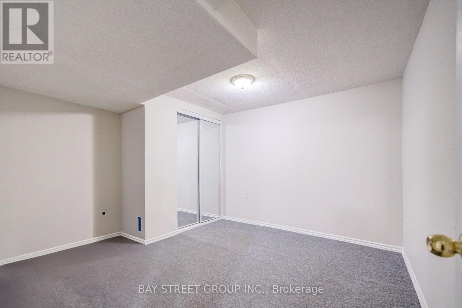 A room with a carpeted floor and a sliding door.