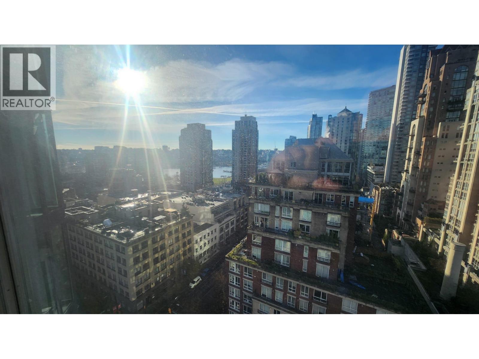 A cityscape with the sun shining through the window.