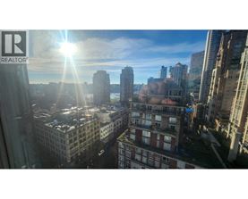 A cityscape with the sun shining through the window.