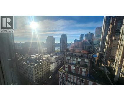 A cityscape with the sun shining through the window.