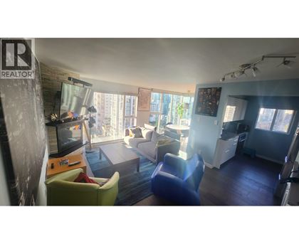 A living room with a television, two chairs, and a couch.
