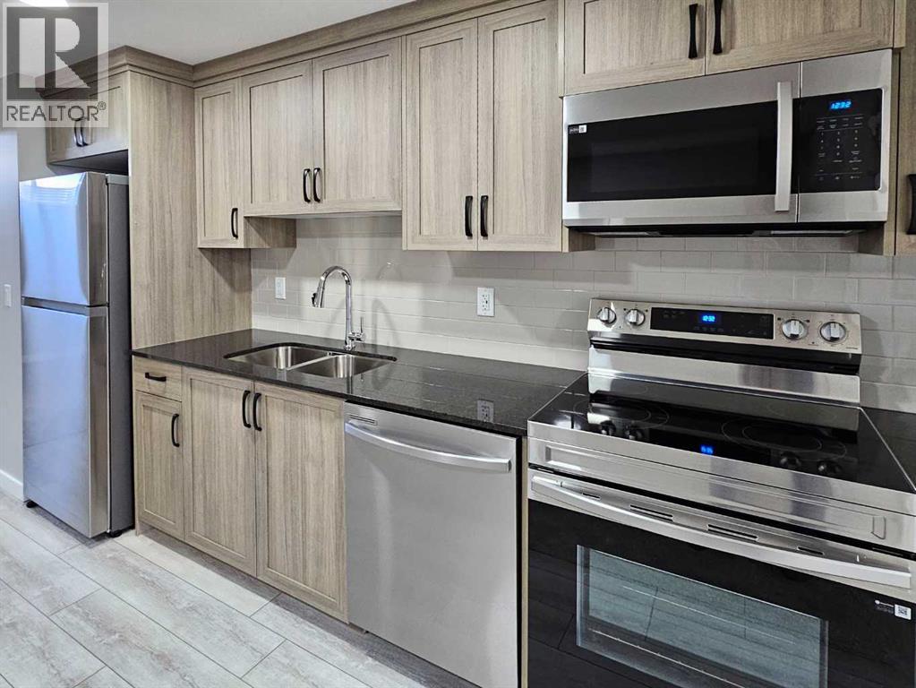 A modern kitchen with wooden cabinets and stainless steel appliances.