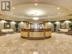 A reception area with a wooden desk and a Realtor sign.