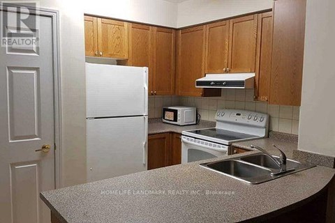A kitchen with a white refrigerator, a white microwave, and a white oven.