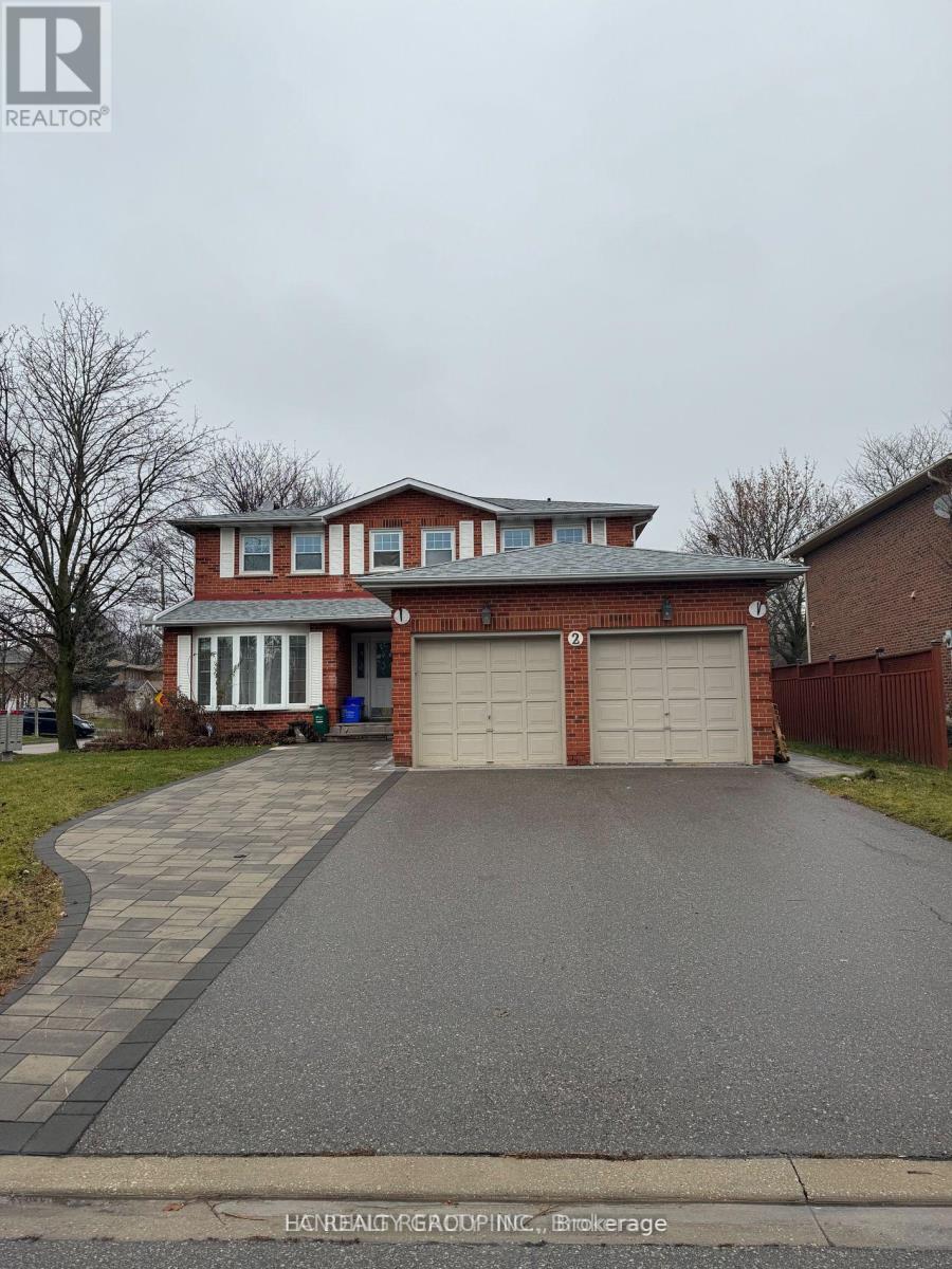 A red brick house with a white garage door.
