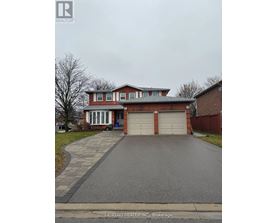 A red brick house with a white garage door.