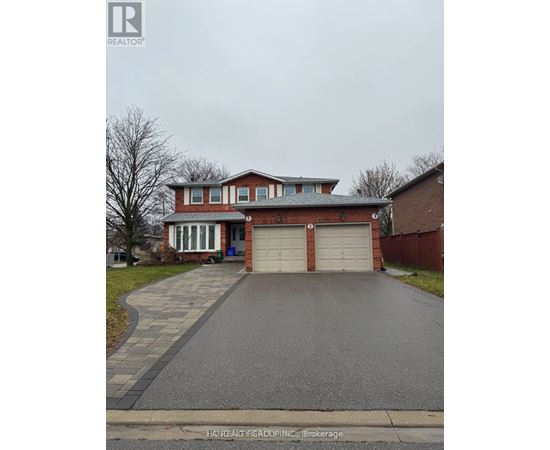 A red brick house with a white garage door.