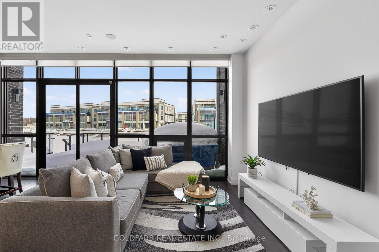A modern living room with a large window overlooking the city.