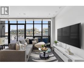 A modern living room with a large window overlooking the city.
