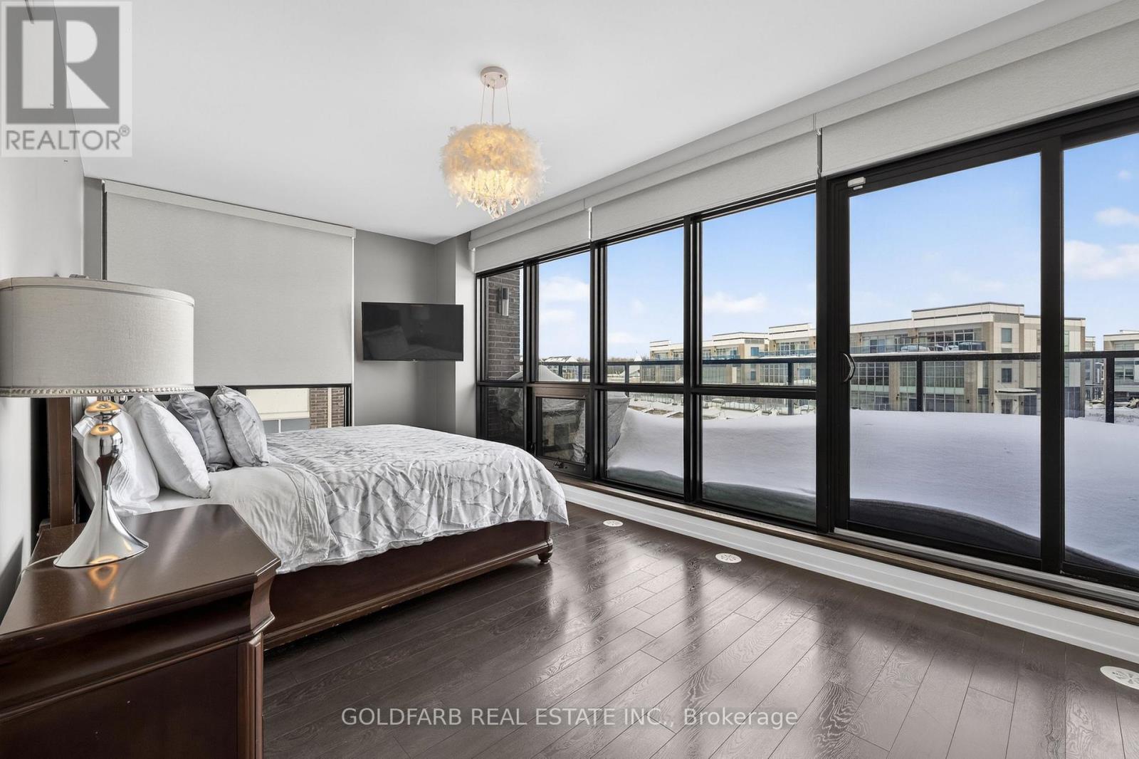 A bedroom with a large bed and a view of the outside.