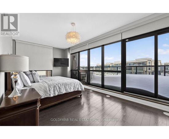 A bedroom with a large bed and a view of the outside.