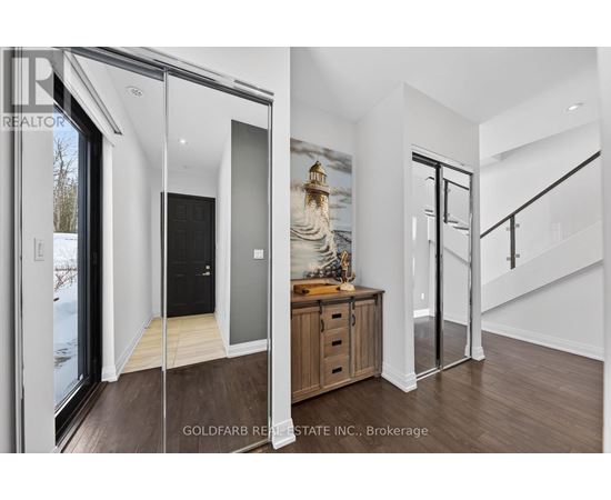 A modern interior space with a wooden floor and a staircase.