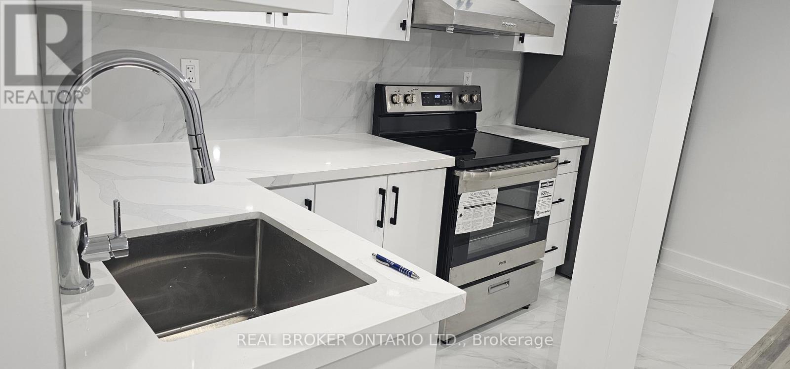 A modern kitchen with a sink and stove.