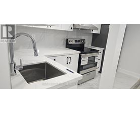 A modern kitchen with a sink and stove.