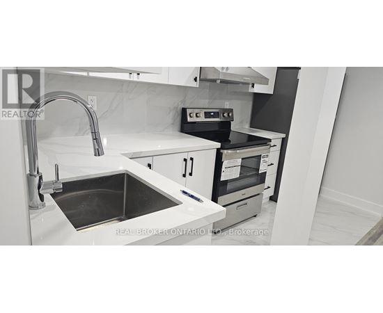 A modern kitchen with a sink and stove.