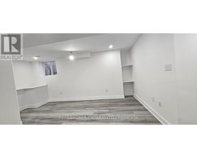 A spacious room with a window and a shelf is available for rent.