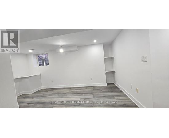 A spacious room with a window and a shelf is available for rent.