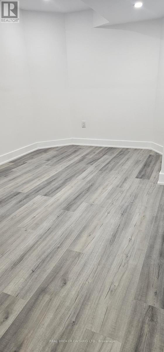 A room with a wooden floor and white walls.