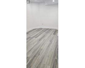 A room with a wooden floor and white walls.