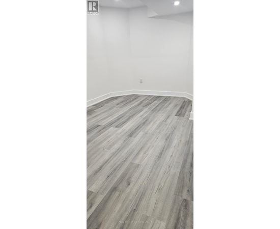 A room with a wooden floor and white walls.