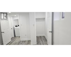 A bedroom with a bed, dresser, and closet.