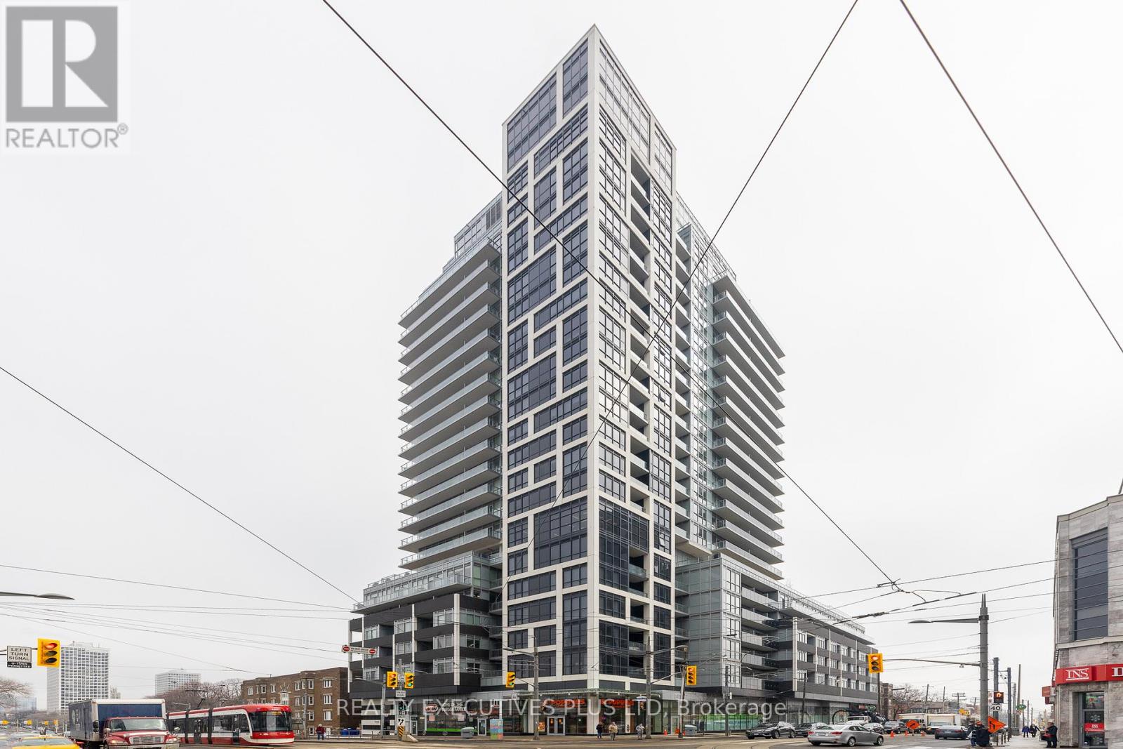 A tall building with many windows is under construction.