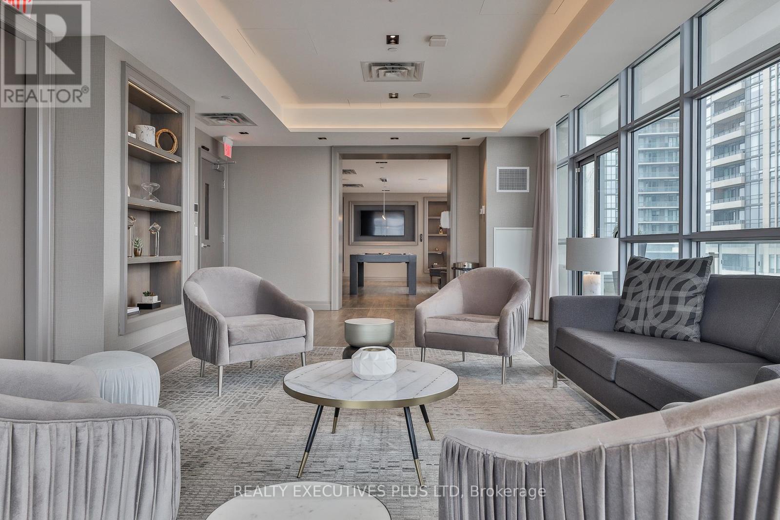 A living room with grey furniture and a flat screen TV.