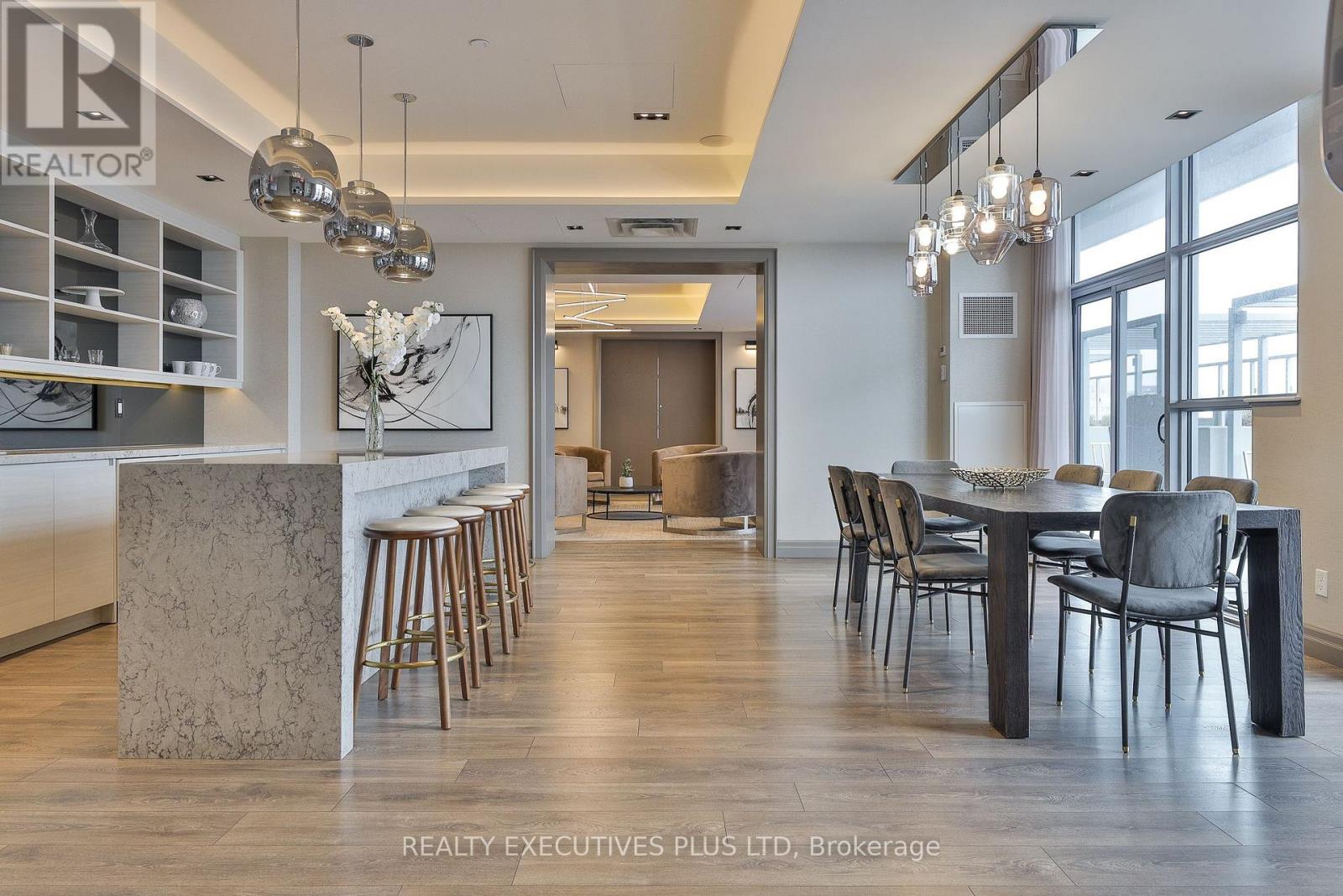 A modern dining room with a large table and chairs.