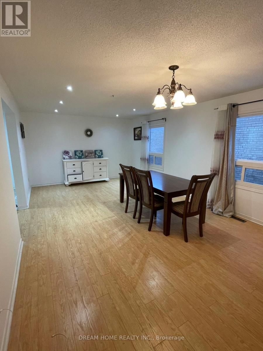 A dining room with a wooden table and chairs.