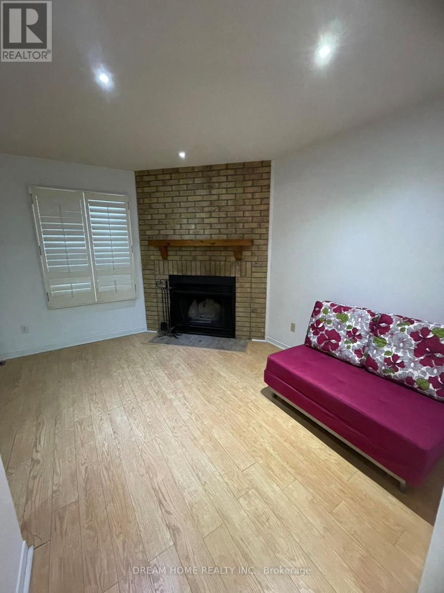 A living room with a fireplace and a couch.