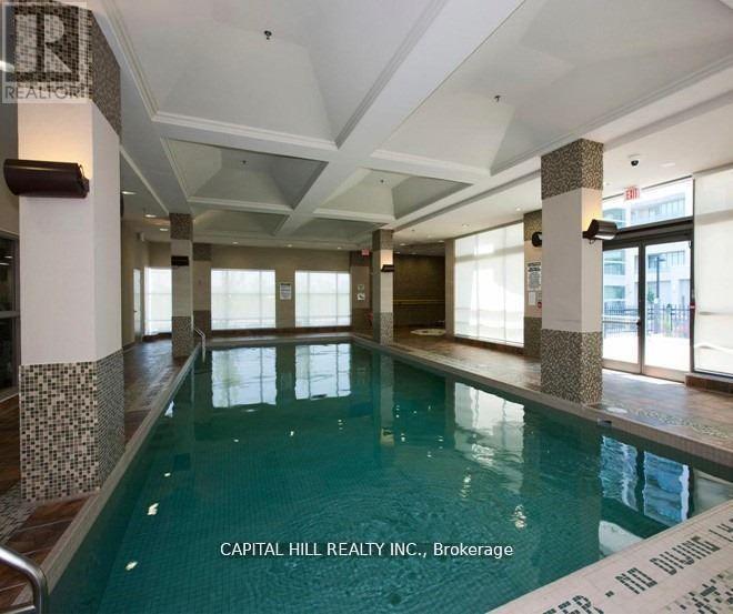 A large indoor swimming pool with tiled walls and floor.