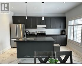 A modern kitchen with a large island and stainless steel appliances.