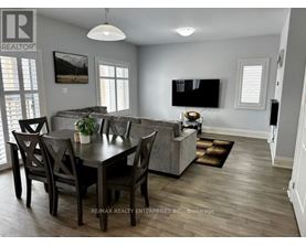 A dining room with a table set for four.