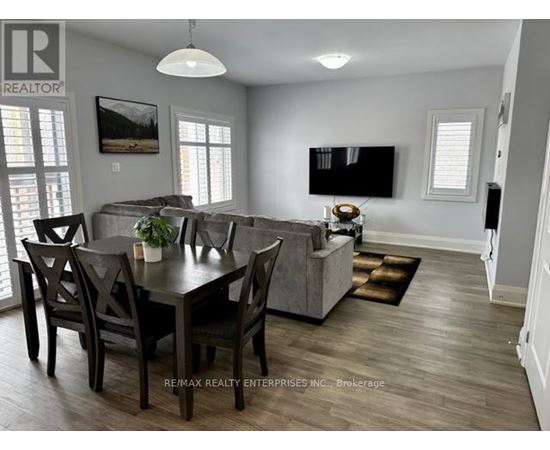 A dining room with a table set for four.
