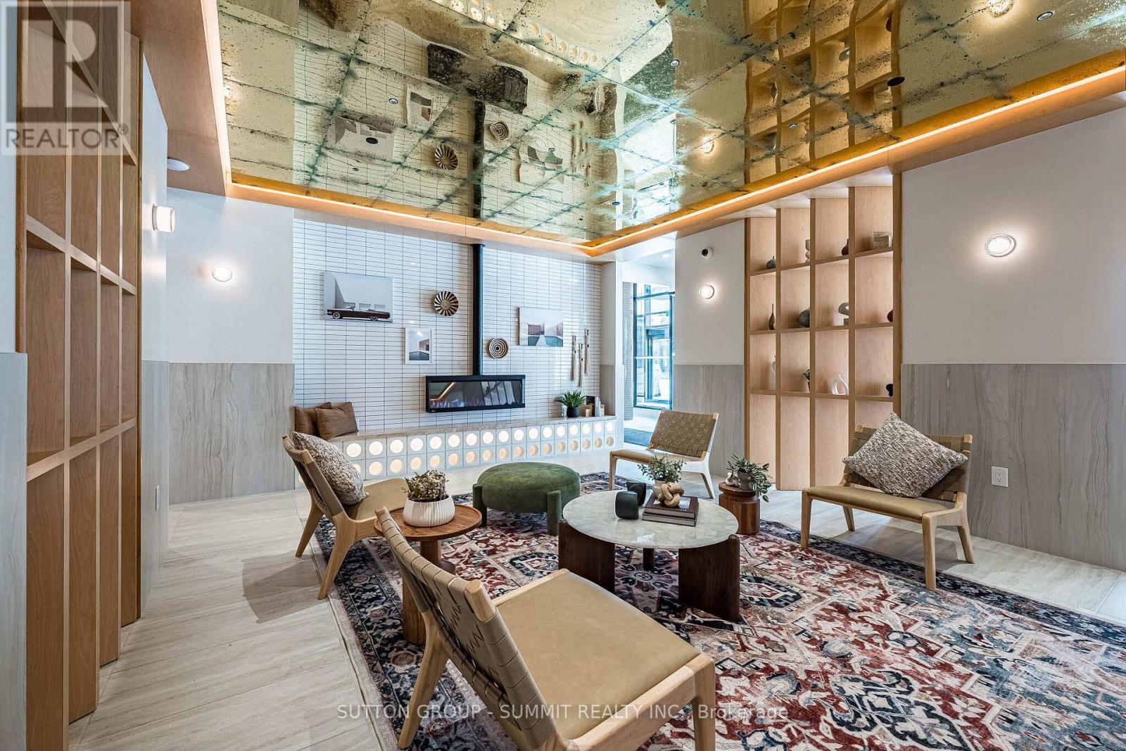 A living room with a rug and wooden furniture.